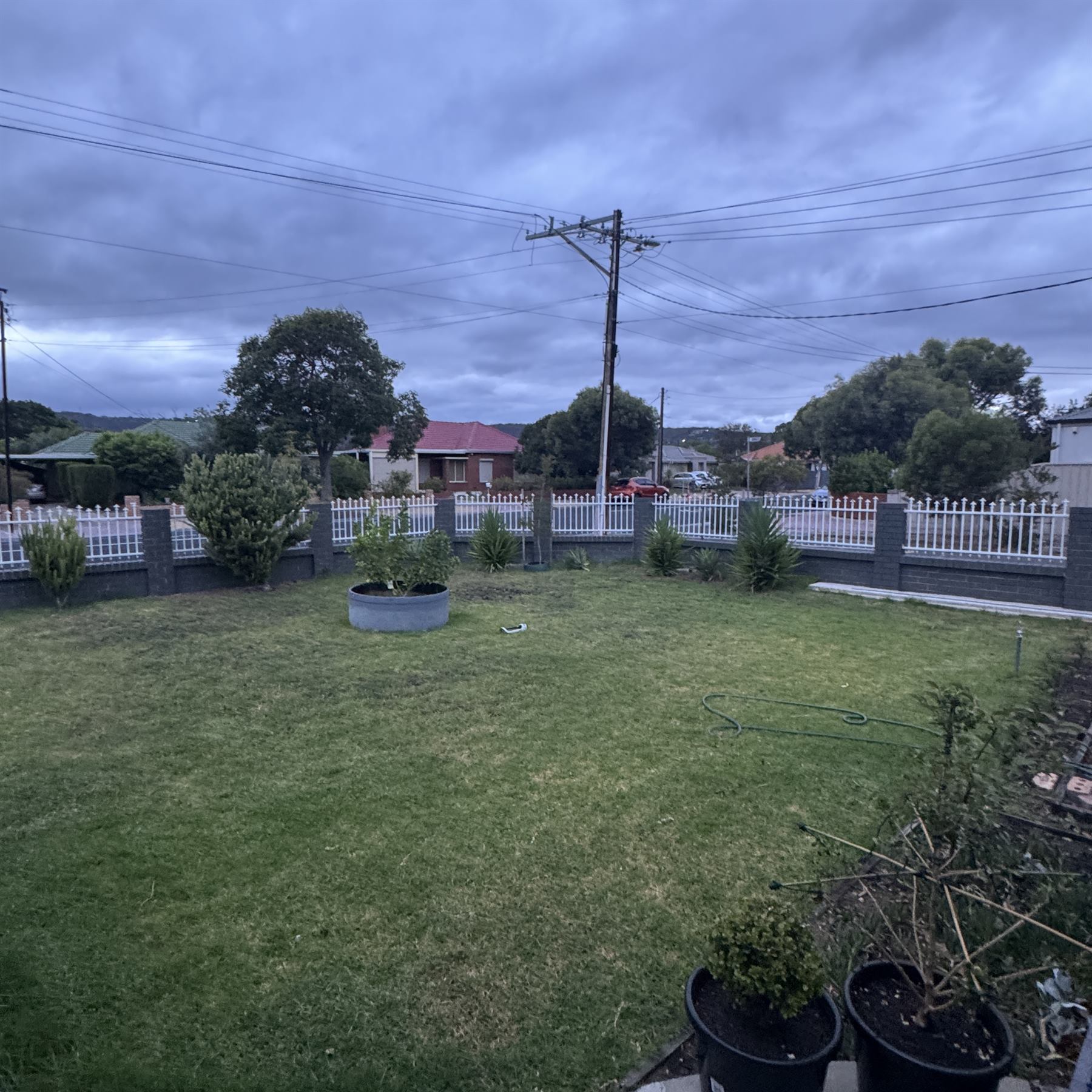 Lawn-heavy front garden section before new edging and planting work